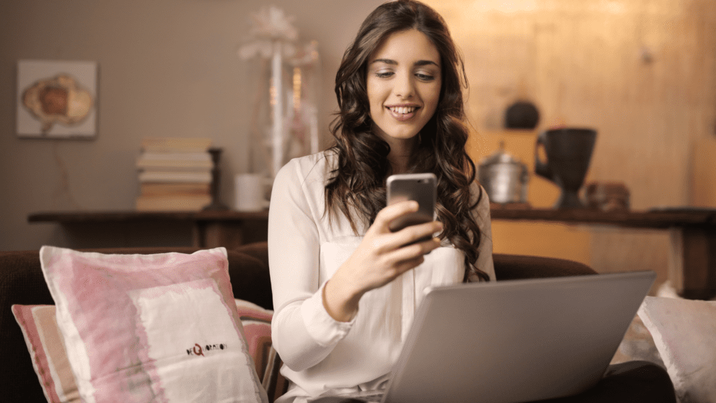 Woman holding a cell phone and smiling