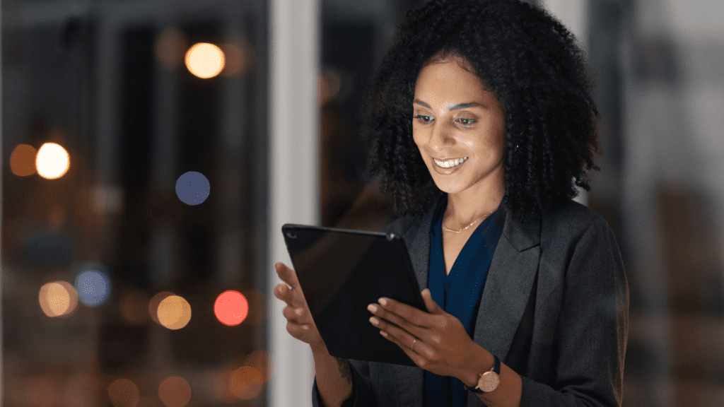 Woman looking at tablet while smiling