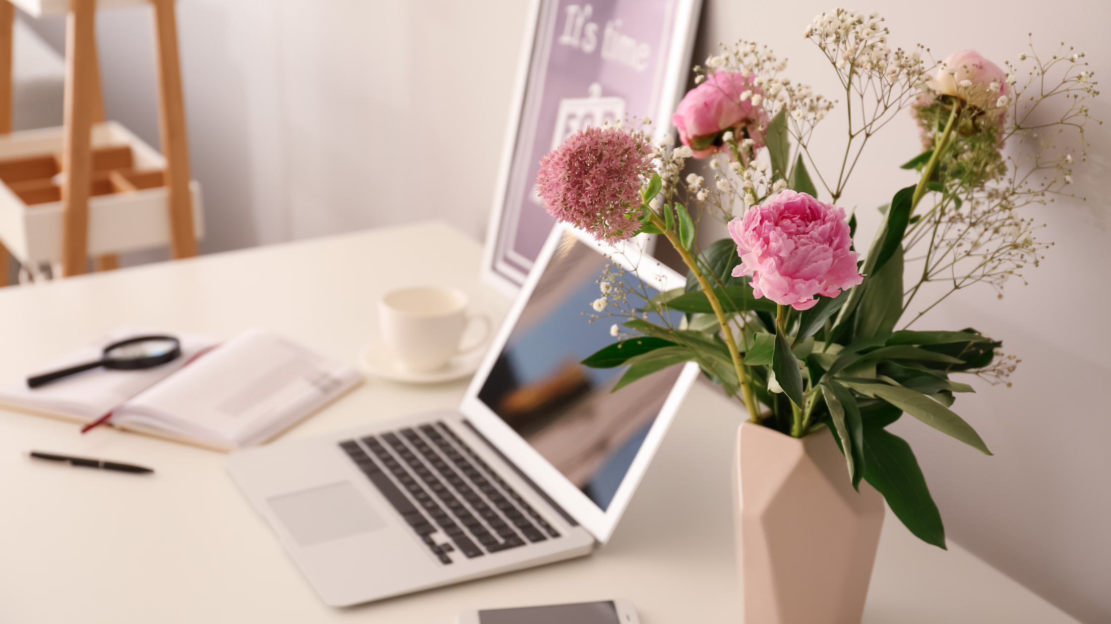 Laptop on desk with vase