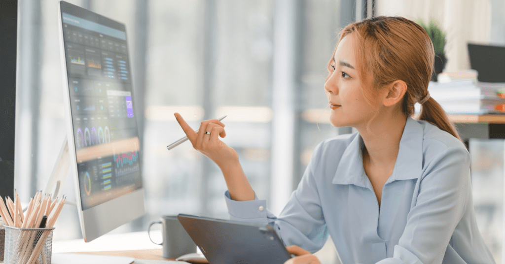 woman looking at a computer screen with analytics from Threads