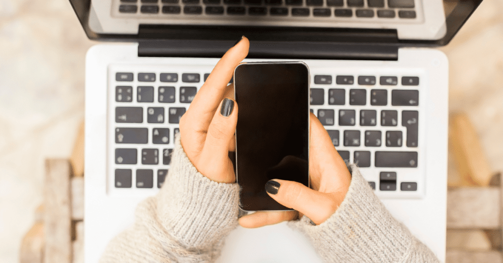 woman on cell phone and laptop