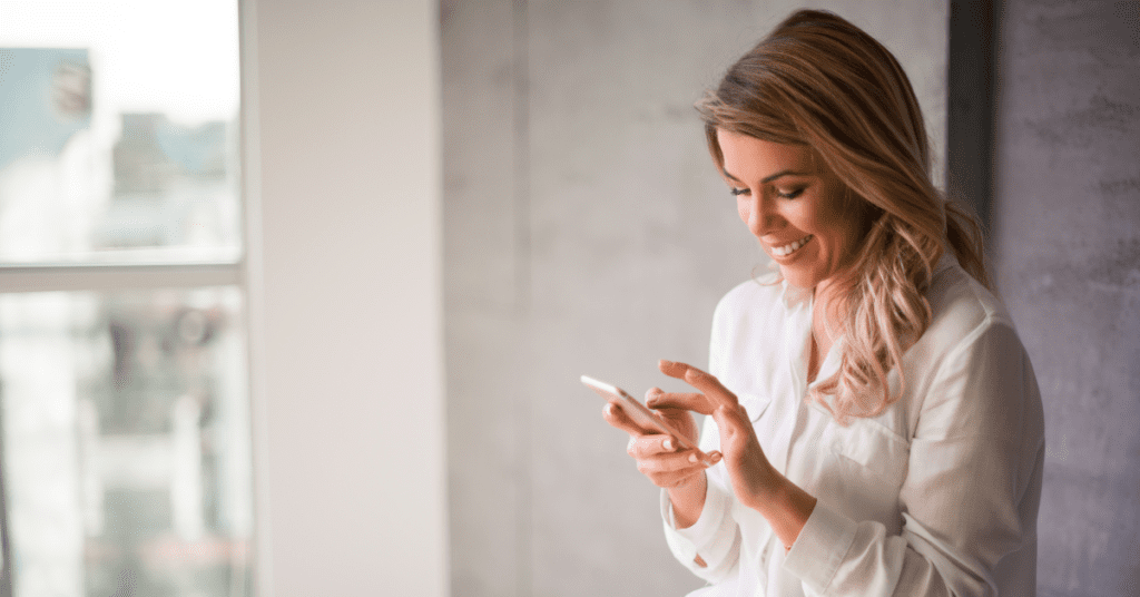 Woman looking at Threads on her phone