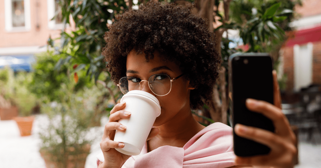 influencer sipping coffee while videoing