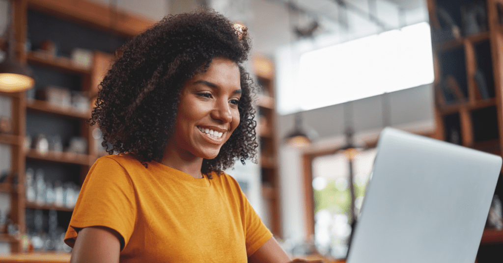 Facebook timing is key - woman on laptop smiling